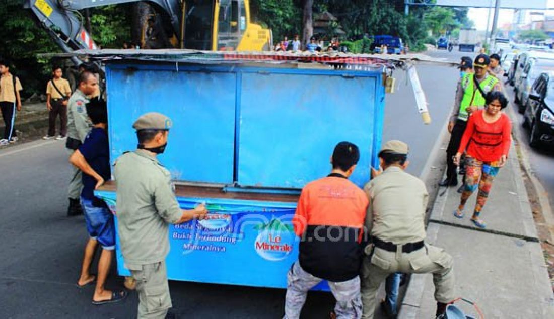 Satuan Polisi Pamong Praja (Satpolpp) Kabupaten Bogor saat melakukan pembongkaran lapak pedagang kaki liar yang berjualan disisi jalan raya Bogor - Jakarta, Cibinong, Kabupaten Bogor, Kamis (28/1). Foto: Fadli/METROPOLITAN/JPNN.com - JPNN.com