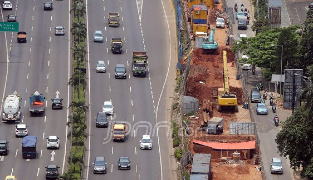 Pekerja mengerjakan pembangunan jalur layang Mass Rapid Transit (MRT) di Jalan TB Simatupang, Jakarta Selatan, Minggu (27/3). Pembebasan lahan yang sulit membuat pembangunan MRT Jakarta yang sedang digarap saat ini mengalami sedikit kendala dan mengakibatkan pengoperasian MRT yang dijadwalkan bisa dilakukan pada 2018 harus mundur menjadi tahun 2019. Foto : Ricardo/JPNN.com - JPNN.com