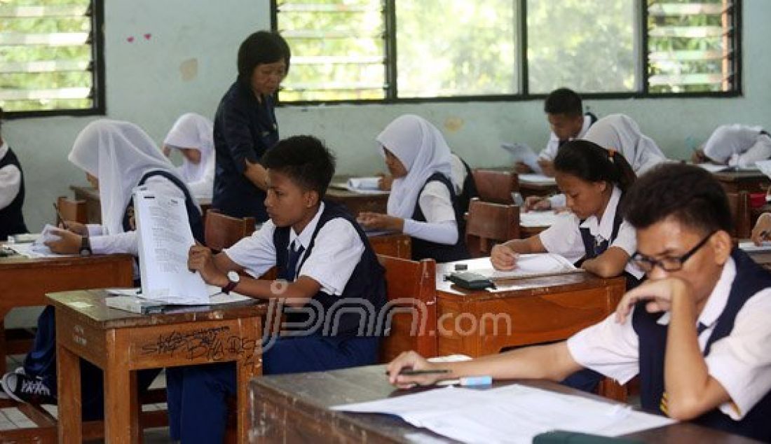 Siswa-siswi SMPN 4 Jakarta saat mengikuti Ujian Nasional, Jakarta, Senin (9/5). Pihak sekolah dan siswa optimis UN 2016 akan berjalan dengan lancar. Foto: Ricardo/JPNN.com - JPNN.com