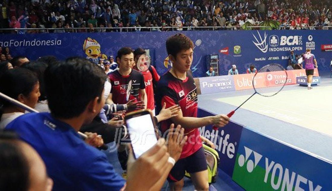 Suporter Indonesia menyambut Ganda putra Korea Selatan Lee Yong Dae (depan) dan Yoo Yeon Seong ketika memasuki lapangan pada Kejuaraan BCA Indonesia Open Super Series Premier 2016, Jakarta, Rabu (1/6). Foto: Ricardo/JPNN.com - JPNN.com