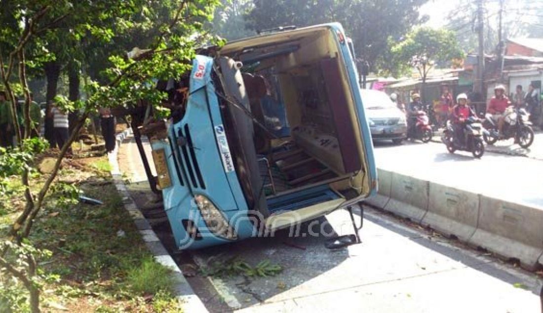 Sebuah bus TransJakarta bernopol B 7700 VK terbalik di Jalan Warung Jati Barat, Pasar Minggu, Jakarta Selatan, Selasa (7/5). Diduga, sang sopir yang bernama Joko Prasetyo mengemudikan kendaraan dalam keadaan mengantuk. Foto: Fathan/JPNN.com - JPNN.com