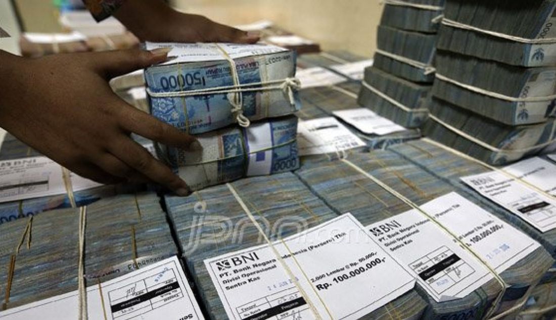Petugas menyusun uang di Cash Center Bank BNI di Jakarta, Jumat (24/6). PT Bank Negara Indonesia Tbk menyiapkan uang tunai senilai Rp 64,07 triliun untuk memenuhi kebutuhan uang menjelang Lebaran. Dari Rp 64,07 triliun, Rp 30,24 triliun disalurkan untuk kebutuhan ATM, Rp 32,46 triliun kebutuhan outlet, dan sisanya Rp 1,375 triliun di setor ke Bank Indonesia (BI). Foto : Ricardo/JPNN.com - JPNN.com