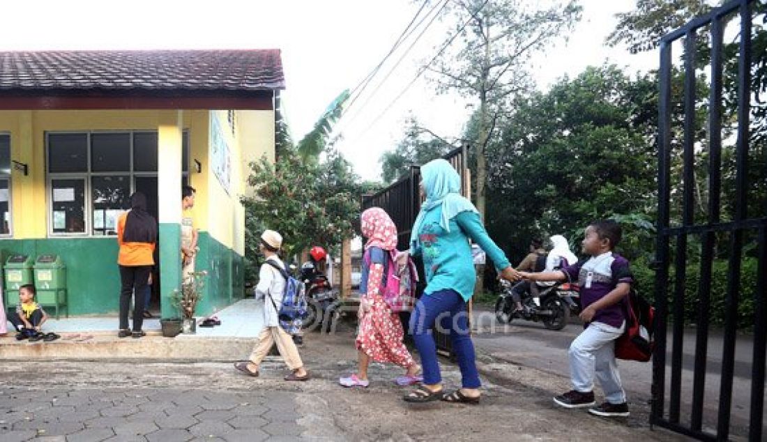 Orang tua siswa saat mengantarkan anaknya ke SDN Nanggerang 01, Tajurhalang, Kabupaten Bogor, Senin (18/7). Para orang tua sangat mendukung dengan intruksi Menteri Pendidikan dan Kebudayaan Anies Baswedan yang menghimbau agar orang tua mengantar anak di hari pertama sekolah dan bertemu dengan gurunya. Foto: Ricardo/JPNN.com - JPNN.com