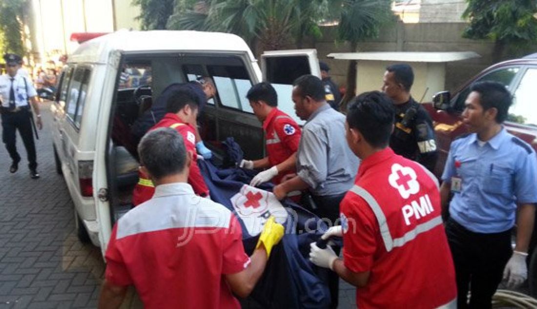 Petugas membawa jenazah Ferry Ekowarno (34), warga Tanah Merah, Kedinding, Kenjeran, kota Surabaya yang tewas akibat bunuh diri dengan cara meloncat dari atas gedung parkiran mobil lantai 6, Rabu (27/7). Foto: Zainal/Radar Surabaya - JPNN.com