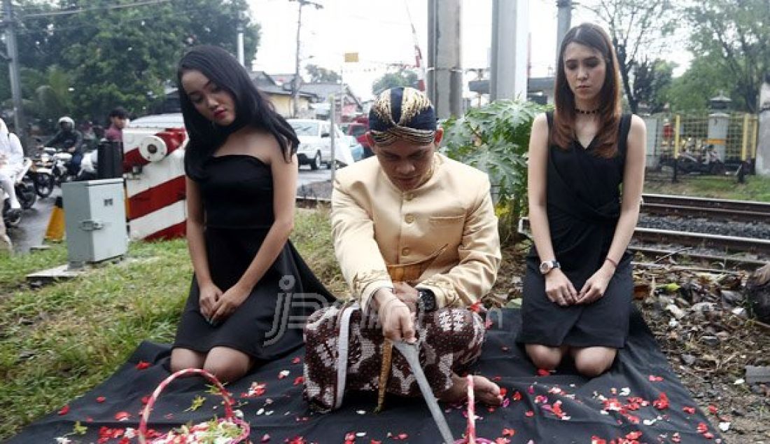 Mbah Mijan bersama model melakukan ruwatan di Perlintasan Kereta Api Bintaro, Jakarta Selatan, Senin (10/10). Peristiwa ini untuk mengenang Tragedi Kecelakaan Antara Mobil Tanki Pertamina dengan KRL. Foto: Ricardo/JPNN.com - JPNN.com