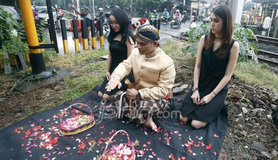 Mbah Mijan bersama model melakukan ruwatan di Perlintasan Kereta Api Bintaro, Jakarta Selatan, Senin (10/10). Peristiwa ini untuk mengenang Tragedi Kecelakaan Antara Mobil Tanki Pertamina dengan KRL. Foto: Ricardo/JPNN.com - JPNN.com