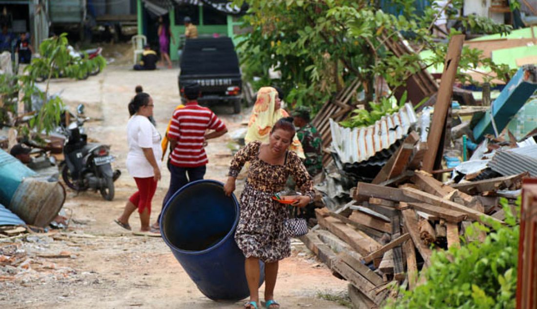 NGOTOT BERTAHAN: Siti Maesaroh bersama penghuni eks Lokalisasi LHB, Km 17, masih bertahan di atas puing-puing bangunan yang diruntuhkan pemkot. Mereka saat ini kekurangan air bersih dan kehilangan tempat berteduh. - JPNN.com