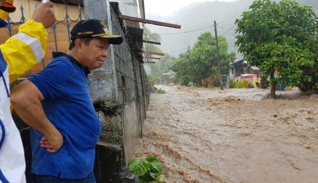 PARAH: Hanya hujan delapan jam, delapan kelurahan di Kota Bitung terendam banjir. Seribu lebih rumah warga terendam banjir setinggi 80 – 120 centimeter. Lima ribu warga diungsikan. Wali Kota Bitung Max Lomban turun ke beberapa lokasi banjir, Minggu (12/2). - JPNN.com