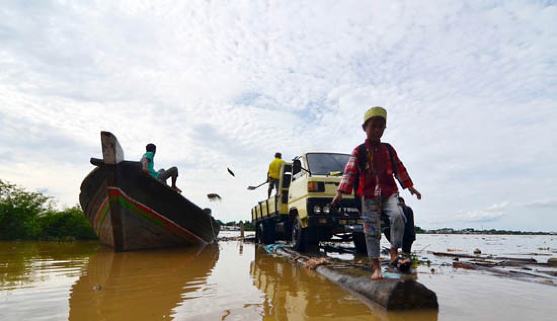 NAIK TERUS: Akibat guyuran hujan deras yang merata di setiap daerah dalam Provinsi Jambi, Debit sungai Batanghari terus naik tentunya akan menjadi ancaman bencana banjir di Provinsi Jambi. Terlihat warga saat beraktifitas di pelabuhan pasir kasang Kota Jambi, Rabu (7/3). - JPNN.com