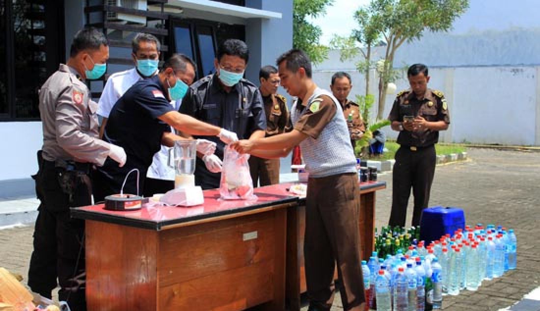 Kejari Sumenep bersama BNNK dan Kepolisian Resort Sumenep, memusnahkan puluhan barang bukti narkoba dan ratusan botol miras di halaman kantor Kejari Sumenep, Rabu (12/4). - JPNN.com