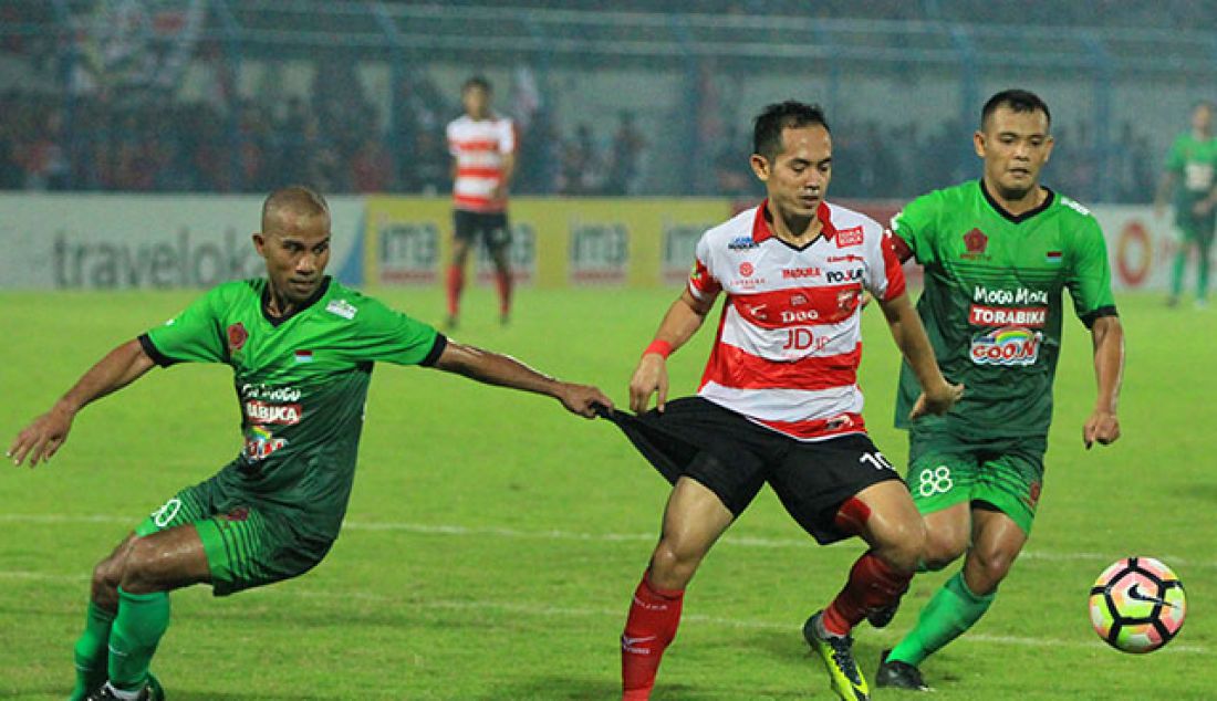 Slamet Nurcahyo (tengah) dikawal pemain PS TNI, pertandingan yang digelar di Gelora Stadion Bangkalan, Jumat (19/5). Pertandingan ini dimenangkan oleh tim tuan rumah dengan skor 4-1. - JPNN.com