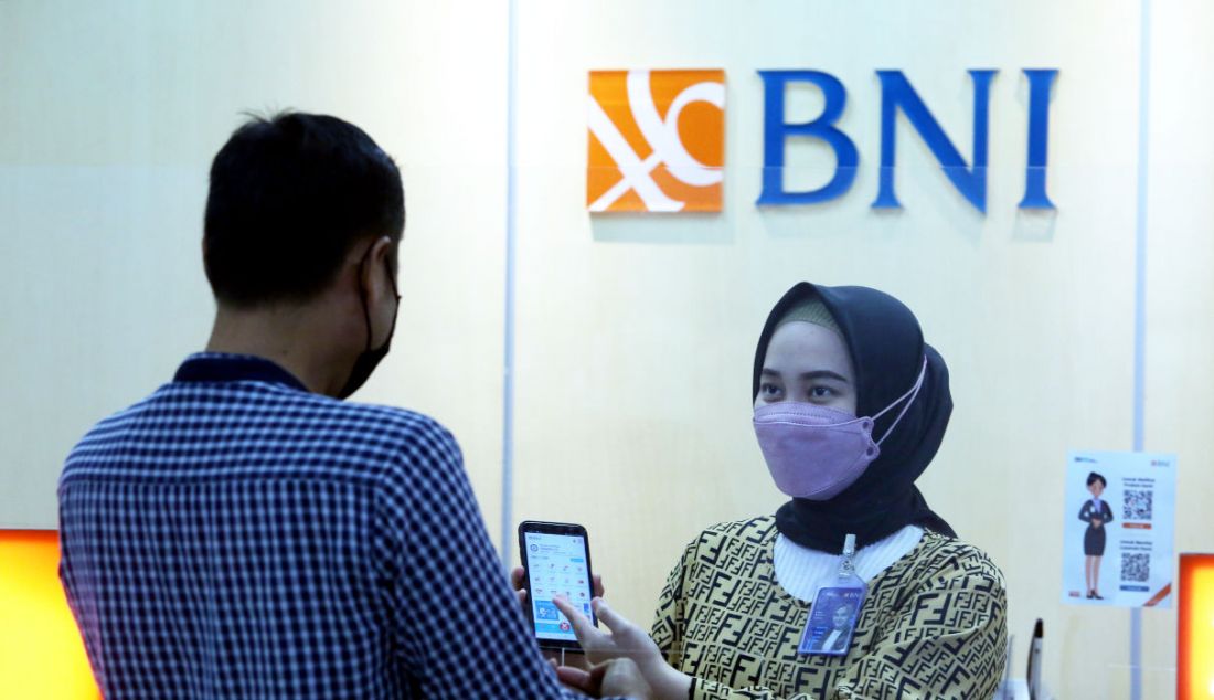 Pegawai BNI menunjukkan aplikasi mobile banking BNI kepada nasabah di salah satu kantor cabang PT Bank Negara Indonesia (Persero) Tbk. di Sentul, Kabupaten Bogor, Jawa Barat, Jumat (17/12). Berdasarkan data BNI nilai transaksi aplikasi mobile BNI mencapai Rp 160 triliun hingga kuartal III/2021. - JPNN.com