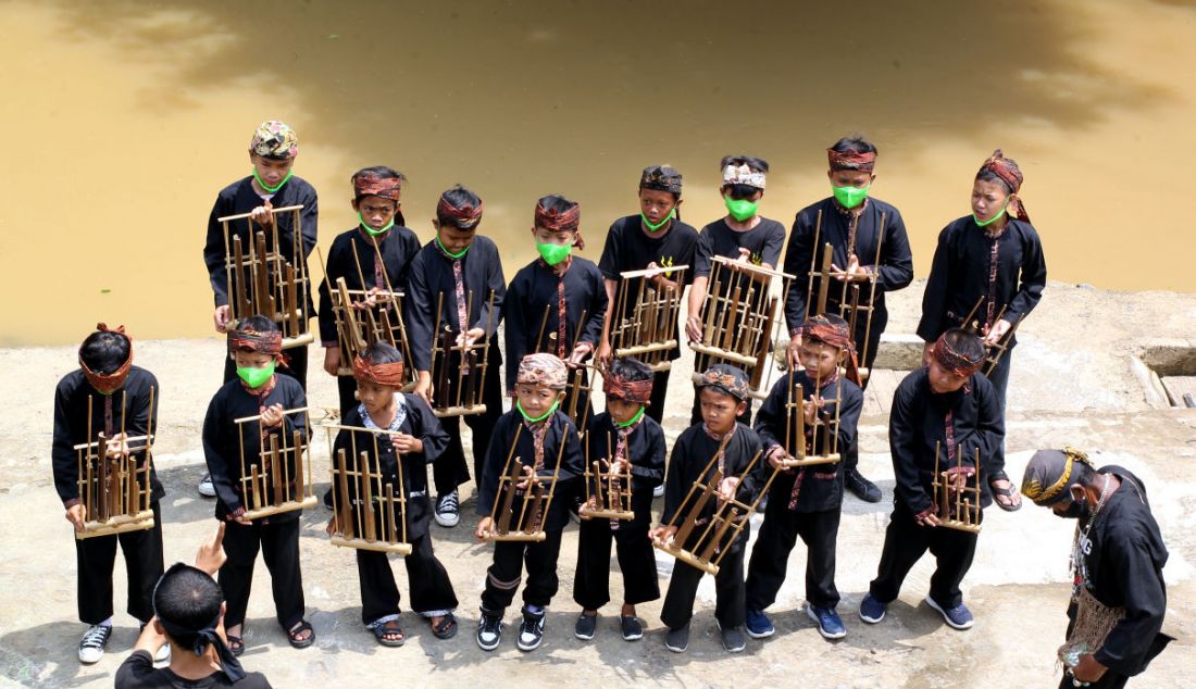 Warga saat memainkan alat musik angklung di Kampung Labirin, Kebon Jukut, Kota Bogor, Jawa Barat, Minggu (30/1). - JPNN.com