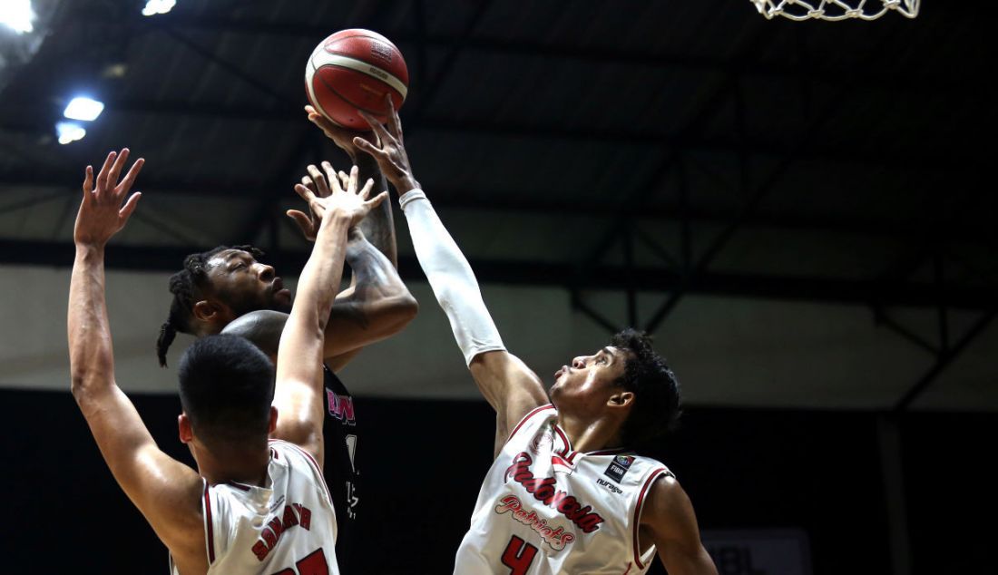 Pemain Indonesia Patriots memblok shooting pemain RANS PIK Basketball Club pada pertandingan Indonesian Basketball League (IBL) 2022 di Hall Basket Senayan, GBK, Jakarta, Jumat (4/3). RANS PIK menang 64-48. - JPNN.com