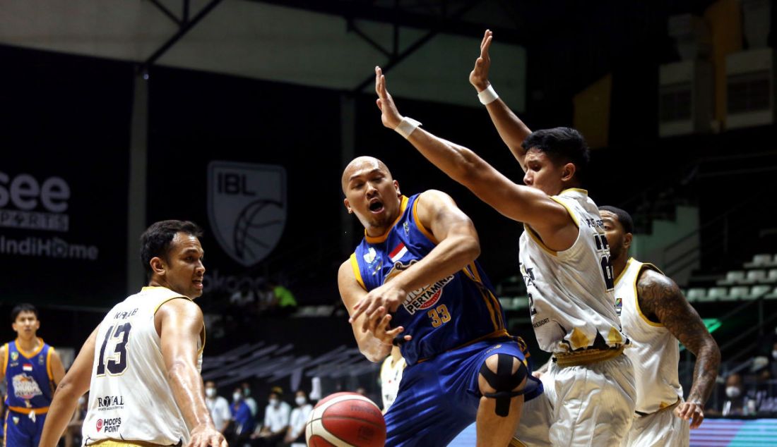 Pemain Satria Muda Pertamina gagal menerobos adangan pemain Dewa United Surabaya pada pertandingan Indonesian Basketball League (IBL) 2022 di Hall Basket Senayan, GBK, Jakarta, Rabu (9/3). - JPNN.com