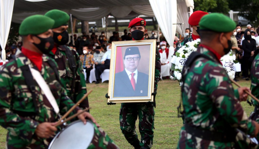 Prajurit TNI membawa foto almarhum Menpan-RB Tjahjo Kumolo di TMP Kalibata, Jumat (1/7). - JPNN.com