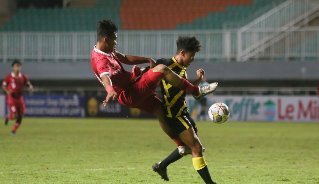 Pemain Timnas U-17 Indonesia Muhammad Nabil Asyura terjatuh seusai berduel dengan pemain Malaysia pada laga Kualifikasi Grup B Piala Asia U-17 di Stadion Pakansari, Kabupaten Bogor, Jawa Barat, Minggu (9/10). Timnas U-17 Indonesia kalah 1-5. - JPNN.com