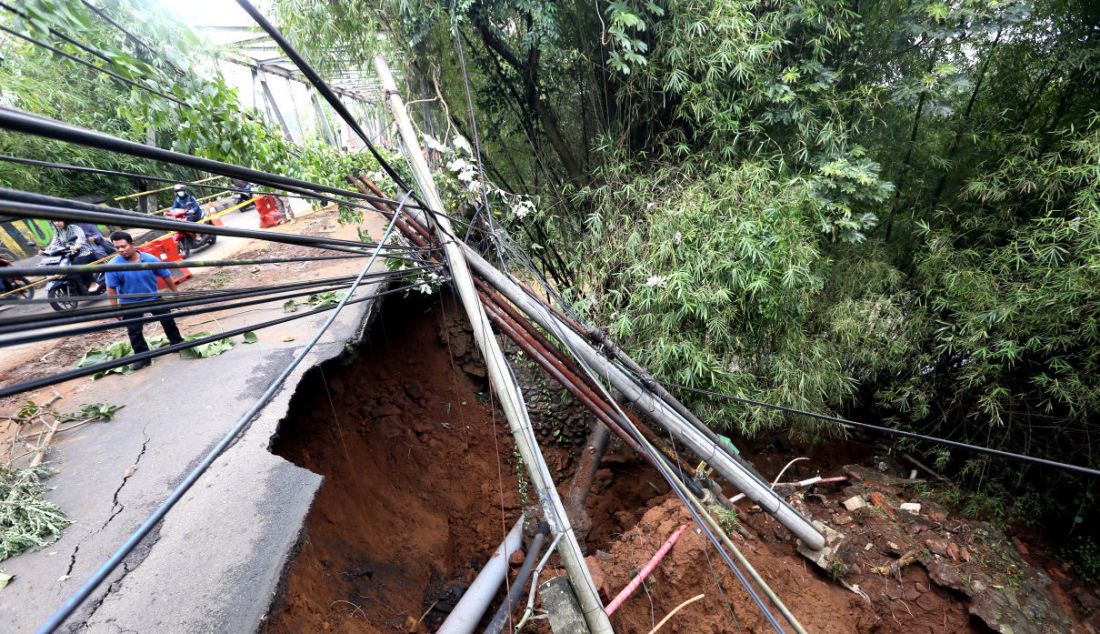 Kondisi ujung jembatan Cisadane Jalan Darul Quran yang mengalami longsor, Bogor, Jawa Barat, Rabu (12/10). Longsor tersebut diakibatkan hujan deras kemarin dan tidak mengalami korban jiwa. - JPNN.com