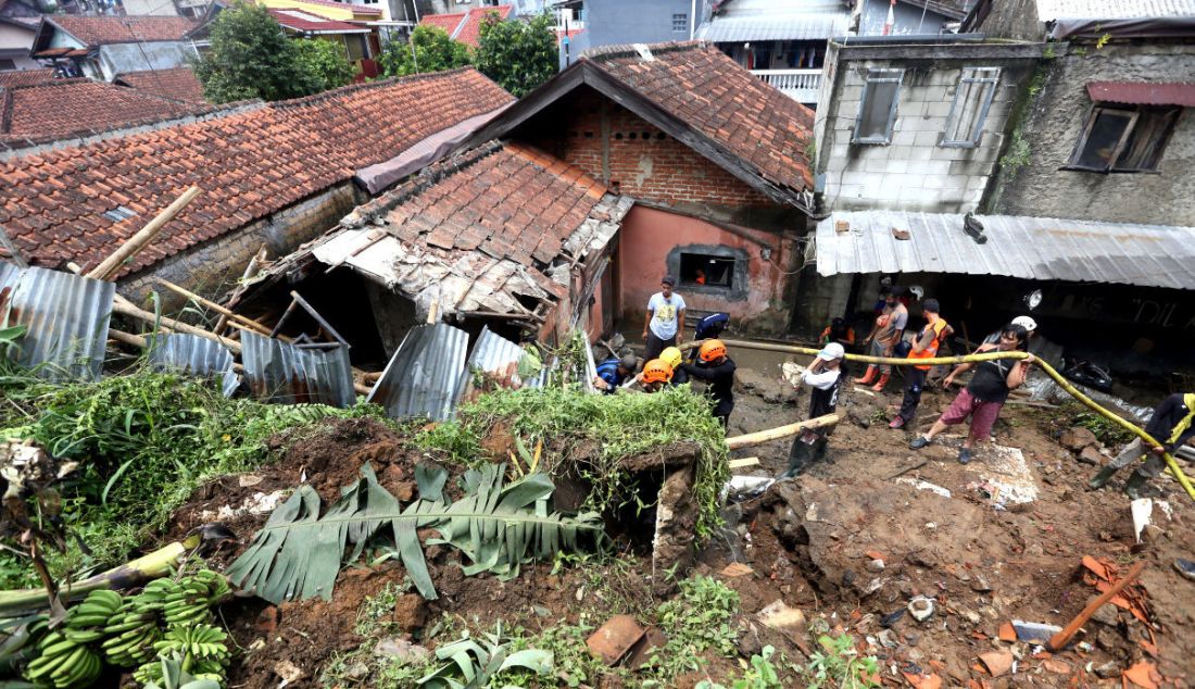 Petugas BPBD Kota Bogor bersama warga membersihkan tempat pemancingan yang longsor di Kelurahan Kebon Kelapa, Kota Bogor, Jawa Barat, Rabu (12/10). Konon satu orang tewas dalam musibah itu. - JPNN.com