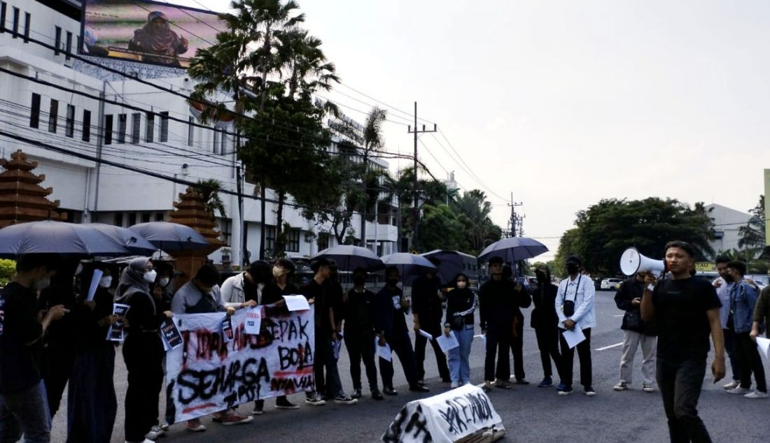 Puluhan suporter Persebaya Surabaya yang tergabung dalam Gerakan Sepak Bola untuk Rakyat (GSR) melakukan Aksi Menolak Lupa Tragedi Kanjuruhan di depan kantor DPRD Provinsi Jawa Timur, Kamis (12/1). Mereka membawa 'keranda mayat' PSSI sebagai simbol kondisi sepak bola Indonesia sedang bersedih karena matinya rasa keadilan atas tragedi yang yang menewaskan 135 orang itu. - JPNN.com