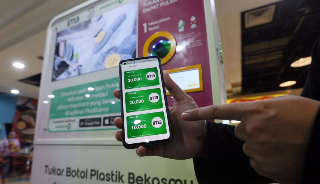 Pengunjung menukarkan botol plastik dengan pulsa IM3 dan Tri melalui Reverse Vending Machine (RVM) Plasticpay di pusat perbelanjaan Bogor Trade Mall (BTM), Bogor, Jawa Barat, Jumat (13/10). - JPNN.com