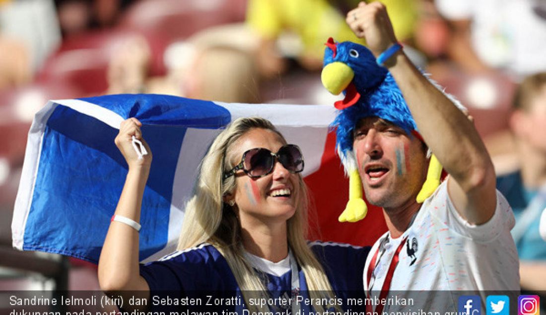 Sandrine Ielmoli (kiri) dan Sebasten Zoratti, suporter Perancis memberikan dukungan pada pertandingan melawan tim Denmark di pertandingan penyisihan grup C Piala Dunia 2018 di Stadion Luzhniki, Rusia, Selasa (26/6). - JPNN.com