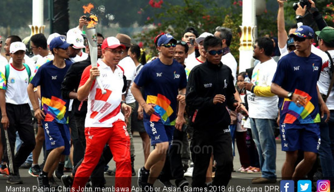 Mantan Petinju Chris John membawa Api Obor Asian Games 2018 di Gedung DPR, Jakarta, Sabtu (18/8). - JPNN.com