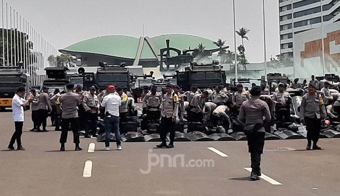 Anggota Kepolisisan bersiaga menjaga jalannya aksi unjuk rasa mahasiswa di depan gedung DPR RI, Senayan, Jakarta, Selasa (24/9). Elemen mahasiswa dari berbagai Universitas menolak UU KPK dan RUU KUHP. - JPNN.com