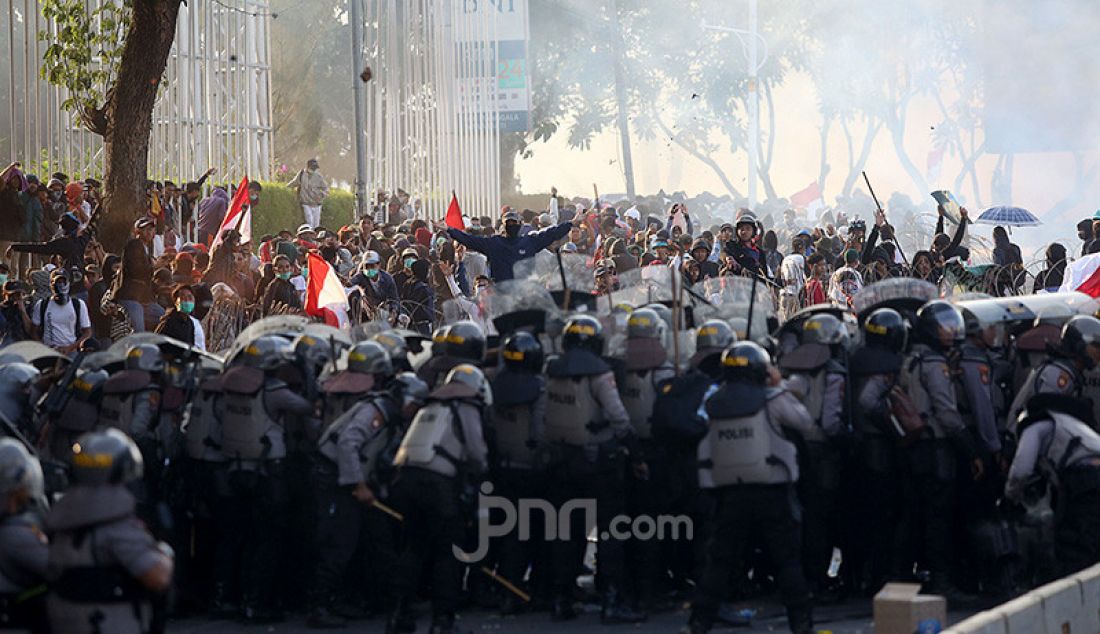 Mahasiswa dan Pelajar saat bentrok dengan aparat kepolisian di kawasan gedung DPR, Jakarta, Senin (30/9). Mereka menolak RKUHP dan RUU KPK. - JPNN.com