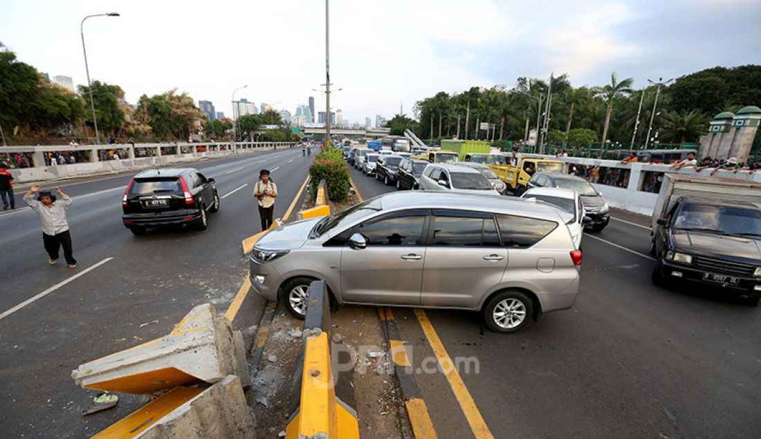 Sejumlah kendaraan berputar balik di depan gedung DPR, Jakarta, Senin (30/9). Jalan Tol Dalam Kota yang menuju Slipi ditutup karena bentrok antara Mahasiswa dan Pelajar dengan Aparat Kepolisian. - JPNN.com