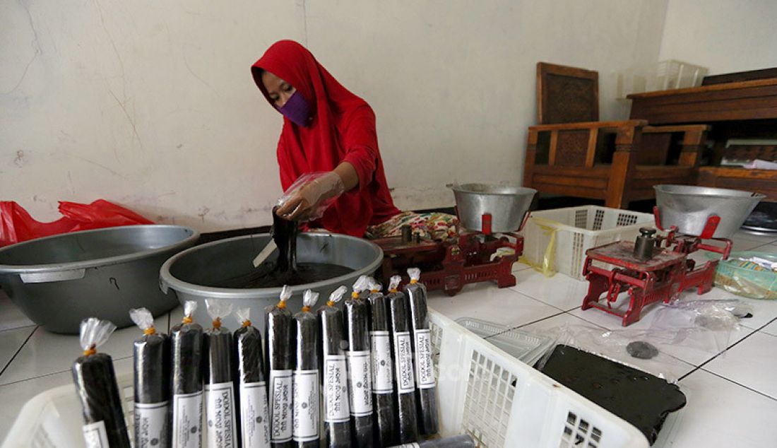 Pekerja mengemas pesanan dodol Betawi di pusat pembuatan dodol di kawasan Cilenggang, Serpong, Tangerang Selatan, Kamis (14/5). Dodol dijual dengan harga Rp 50.000 - Rp 70.000. - JPNN.com