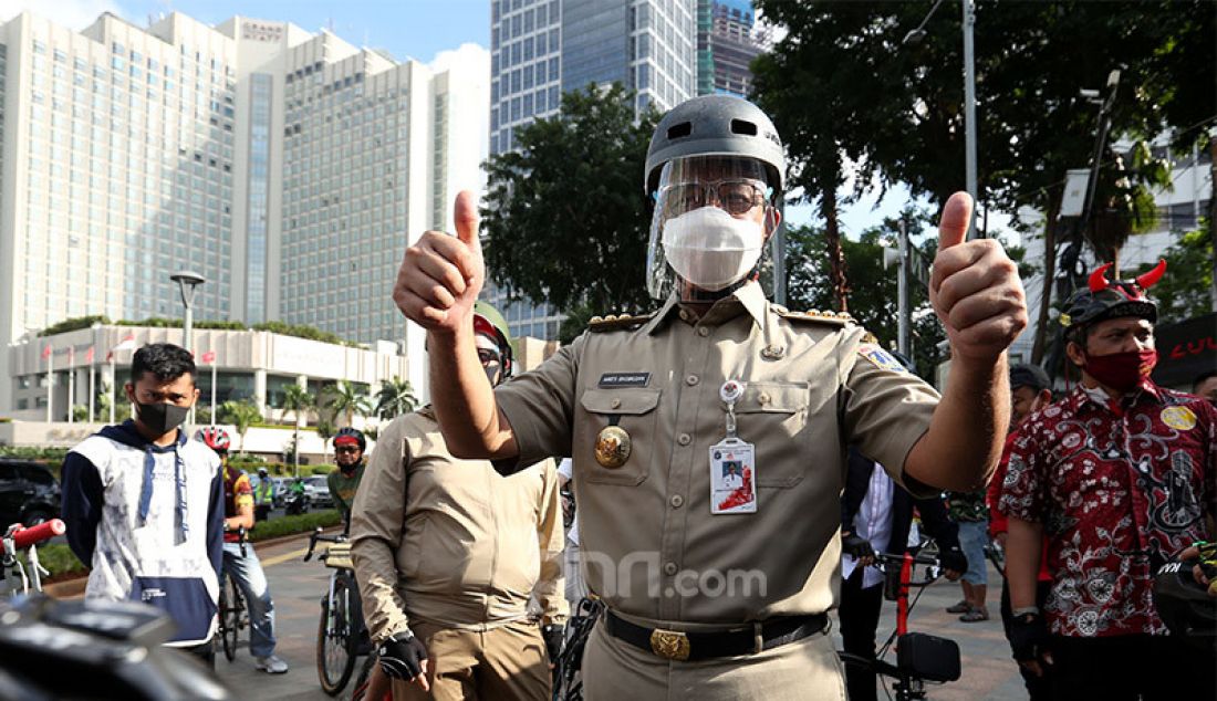 Gubernur DKI Jakarta, Anies Baswedan bersama Wagub Ahmad Riza Patria bersepeda bersama menuju kantor Balaikota, Jakarta, Selasa (16/6). - JPNN.com