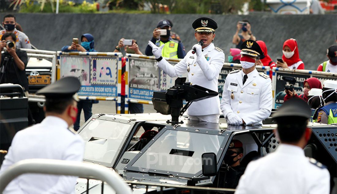 Wali kota Bogor Bima Arya berikan sambutan saat Parade Camat dan Lurah yang dimulai dari rumah dinas Wali Kota Bogor menuju Lawang Salapan, Kota Bogor (17/8). Acara tersebut merupakan rangkaian Festival Merah Putih yang dipimpin Walikota Bogor Bima Arya. - JPNN.com