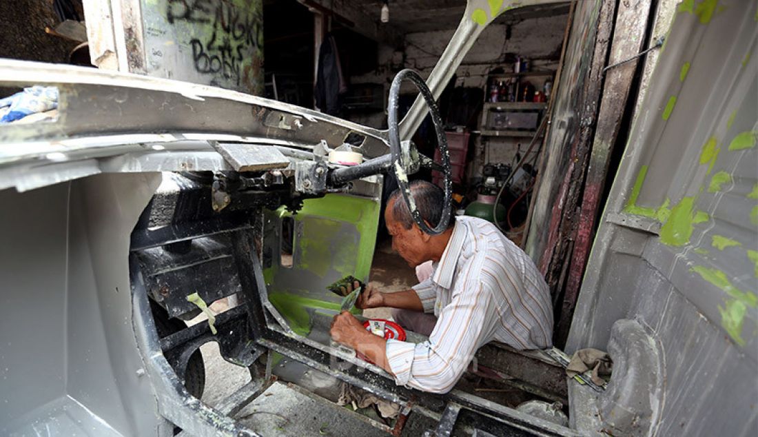 Pekerja memperbaiki becak motor (bemo) di bengkel las Jayadi, jalan Roda Gang Litih, Kelurahan Babakan Pasar, Kota Bogor, Kamis (20/8). Bengkel yang khusus melayani jasa perbaikan bemo yang sudah berdiri sejak tahun 1970 tersebut menjadi tempat favorit bagi sejumlah kolektor kendaraan tua dan langka di wilayah Jabodetabek dan Bandung dengan biaya perbaikan mulai Rp1 juta hingga Rp15 juta tergantung onderdil dan tingkat kerusakan. - JPNN.com