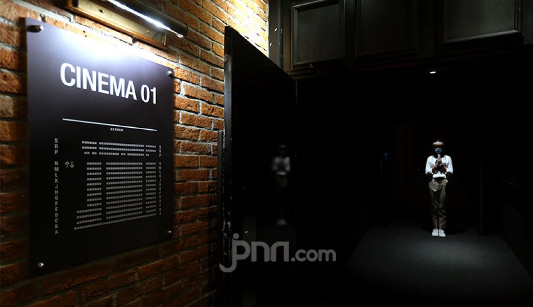 Petugas CGV Grand Indonesia, Jakarta, Rabu (21/10) menyambut pengunjung di pintu masuk sinema. Sejumlah bioskop di Jakarta telah kembali beroperasi setelah mendapatkan izin dari Pemprov DKI Jakarta dengan membatasi jumlah penonton maksimal 25 persen dari kapasitas. - JPNN.com