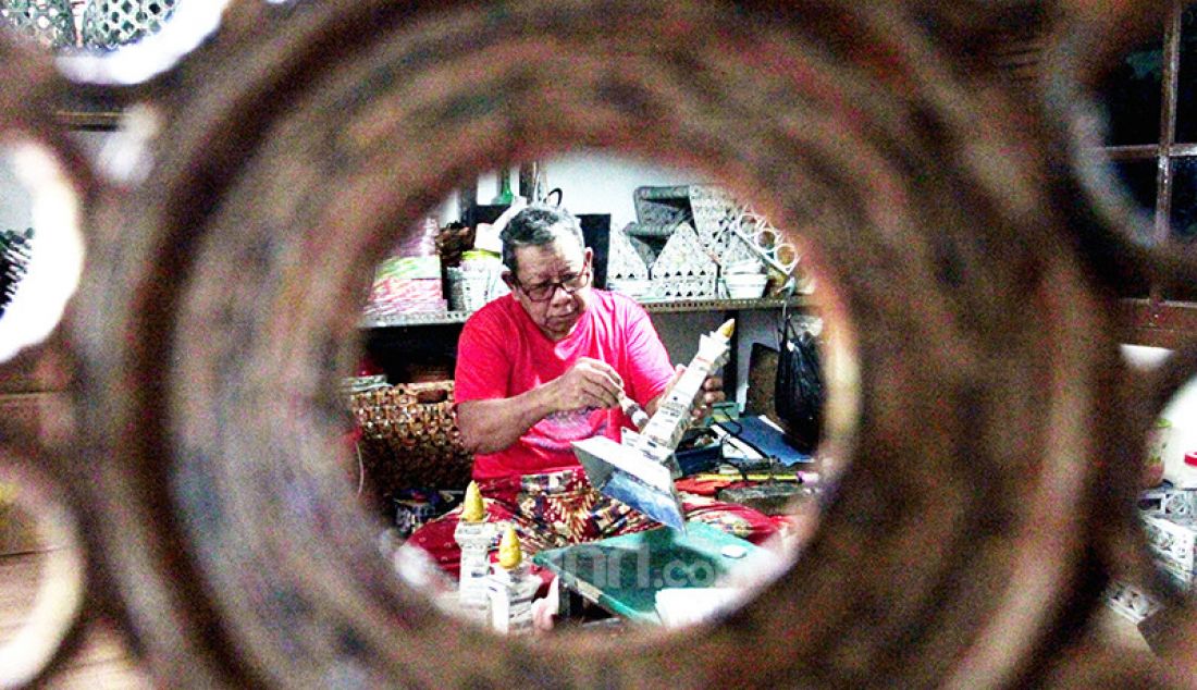 Sugito (68) menyelesaikan pembuatan kerajinan berupa miniatur Monas di Bank Sampah Tri Alam Lestari, Pesanggrahan, Jakarta, Minggu (13/6). Hasil kerajinan yang memanfaatkan limbah kertas koran bekas dari bank sampah tersebut dijual dengan harga antara Rp 50.000 hingga Rp 250.000. - JPNN.com
