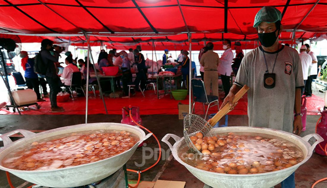 Pekerja mengolah bahan baku masakan di dapur umum Tagana di halaman Gedung Kemenso, Jakarta, Senin (28/6). Kemensos menyiapkan makanan siap saji untuk dibagikan kepada warga dan tenaga kesehatan yang terdampak Covid-19. - JPNN.com