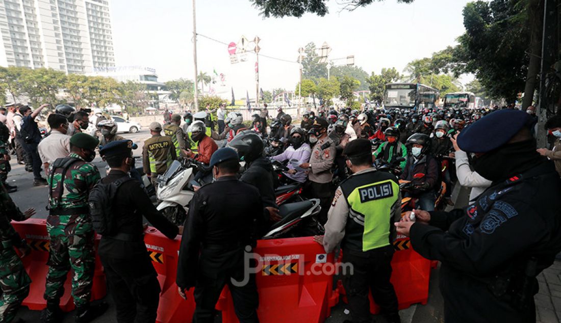 Petugas gabungan dari TNI dan Polri memutarbalik kendaraan yang melintas di pos penyekatan pembatasan menuju Jakarta di kawasan Kalideres, Jakarta, Senin (5/7). Polisi melakukan penyekatan di 63 titik wilayah di Jadetabek saat Pemberlakuan Pembatasan Kegiatan Masyarakat (PPKM) Darurat yang berlangsung hingga 20 Juli 2021. - JPNN.com