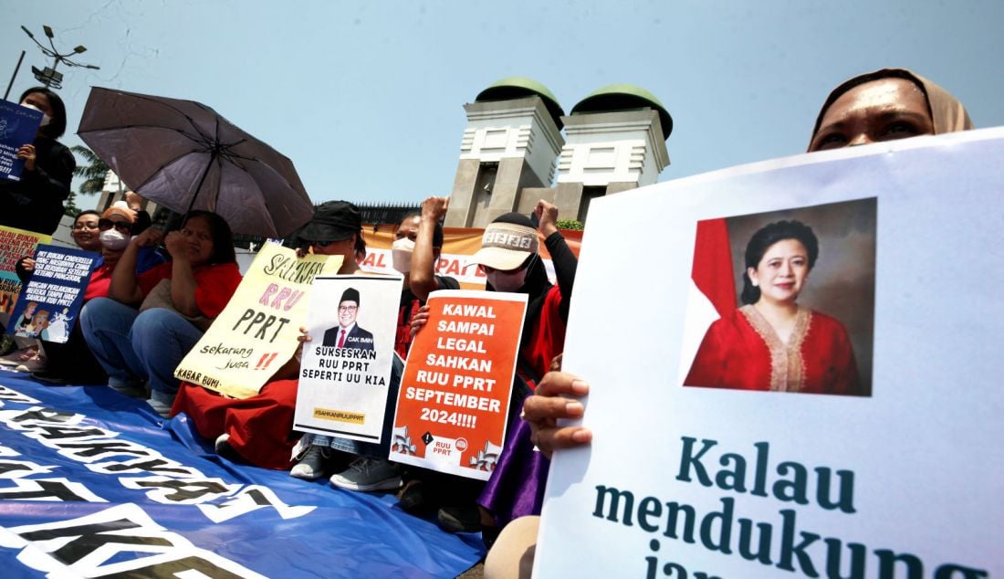 Koalisi Masyarakat Sipil untuk Undang-Undang PPRT menggelar aksi dengan membentangkan poster di depan gedung DPR, Kompleks Parlemen Senayan, Jakarta, Selasa (17/9). Aksi yang digelar memasuki hari kelima tersebut untuk mendesak kepada DPR yang dinilai telah abai terhadap nasih pekerja rumah tangga yang tidak kunjung disahkan. RUU PPRT mandek di DPR sejak 20 tahun lalu dan hingga kini belum juga dibahas dan disahkan. Padahal, peran PRT sangat vital dalam kehidupan sehari-hari masyarakat Indonesia. - JPNN.com