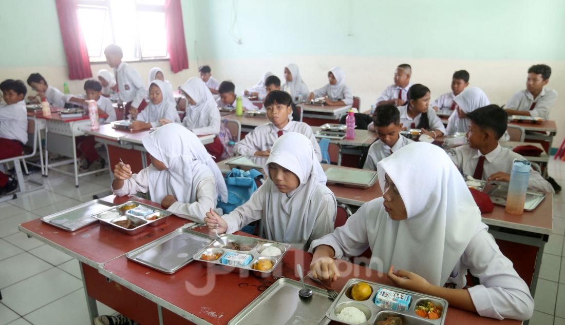 Siswa menikmati makan bergizi gratis (MBM) di SDN Lengkong Wetan 01, Tangerang Selatan, Banten, Senin (6/1). Hari ini program Makan Bergizi Gratis (MBG) yang menjadi program andalan Presiden Prabowo Subianto dimulai perdana pada di 26 provinsi di Indonesia. - JPNN.com